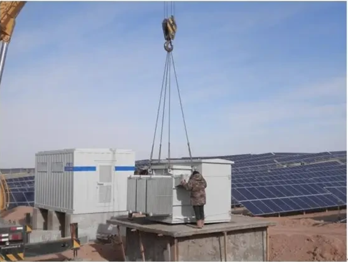 Pad-mounted transformer installed at solar farm with concrete pad and underground cable entry