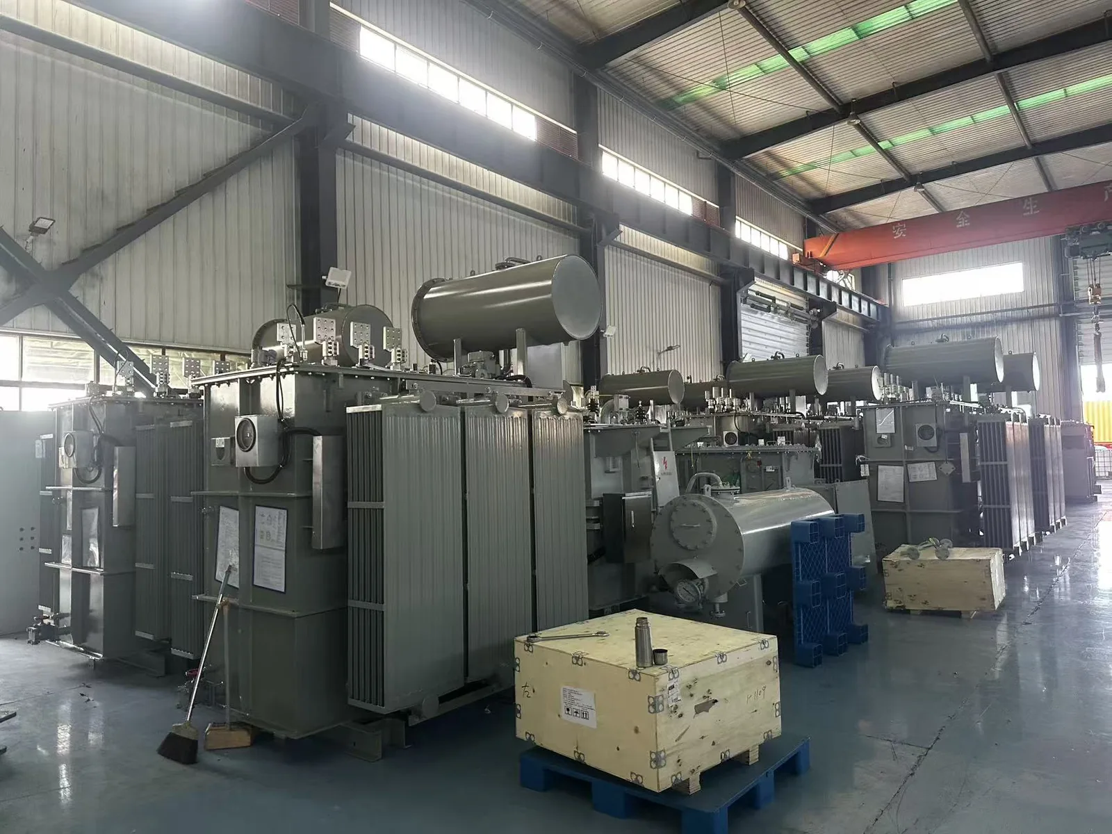 Large oil transformer tank with radiator panels and protective enclosure surface treatment