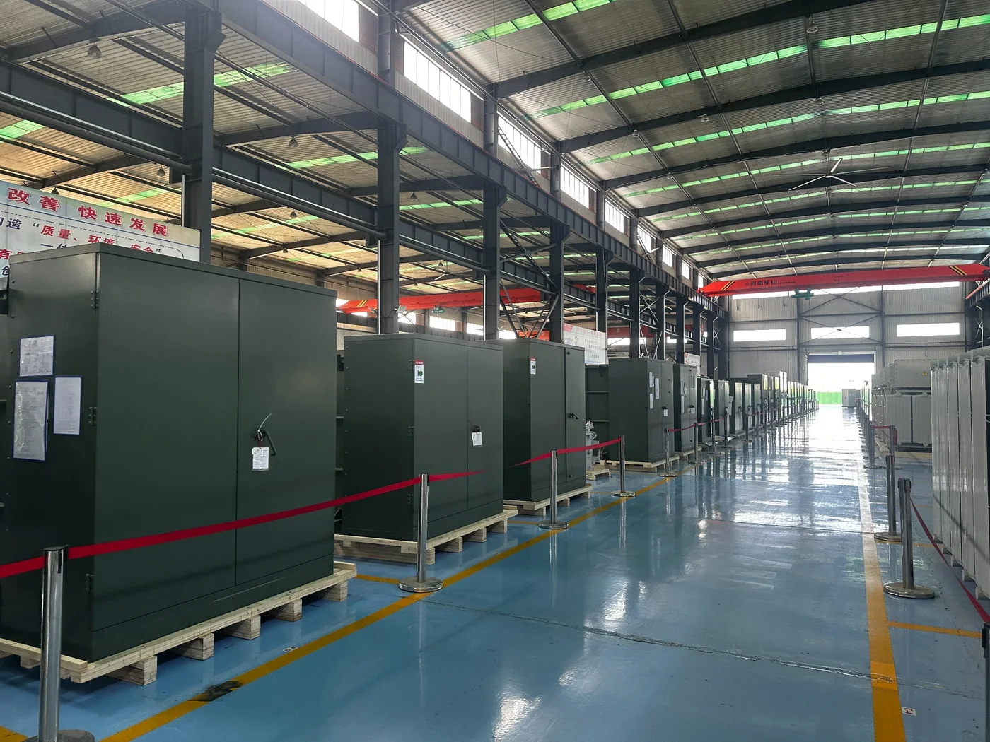 Pad-mounted transformers in factory line for underground power distribution projects